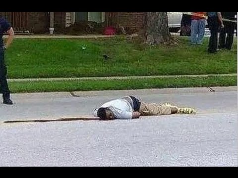 August 9, 2014 Mike Brown lays dead in the street in Ferguson, Missouri after being shot by a police officer.