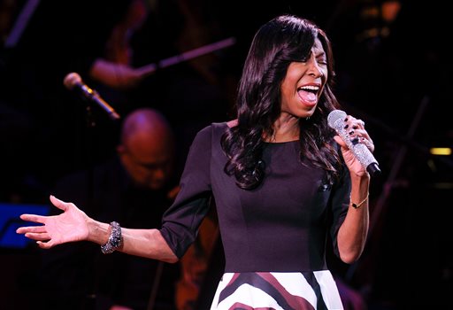 FILE - In a Monday, March 2, 2015 file photo, singer Natalie Cole performs at "An Evening of SeriousFun Celebrating the Legacy of Paul Newman," at Avery Fisher Hall, in New York. Cole, the daughter of jazz legend Nat "King" Cole who carried on his musical legacy, died Thursday night, Dec. 31, 2015, according to publicist Maureen O'Connor. She was 65.(Photo by Evan Agostini/Invision/AP, File)