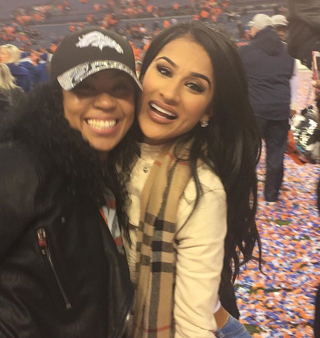 Aqib Talib’s girlfriend and Emmanuel Sanders’ wife cheering on the Denver Broncos.