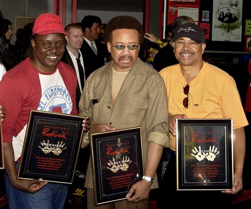 FILE - In this July 7, 2003 file photo, Philip Bailey, from left, Maurice White, and Ralph Johnson, of Earth Wind & Fire hold up the plaques from their induction at the Hollywood Rock Walk at a ceremony in Los Angeles. White, the founder and leader of Earth, Wind & Fire, died at home in Los Angeles, Wednesday, Feb. 3, 2016, said his brother, Verdine White. He was 74. (AP Photo/Matt Sayles, File)