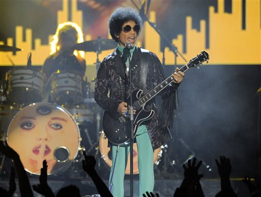 FILE - In this May 19, 2013 file photo, Prince performs at the Billboard Music Awards at the MGM Grand Garden Arena in Las Vegas. Prince, widely acclaimed as one of the most inventive and influential musicians of his era with hits including "Little Red Corvette," ''Let's Go Crazy" and "When Doves Cry," was found dead at his home on Thursday, April 21, 2016, in suburban Minneapolis, according to his publicist. He was 57. (Photo by Chris Pizzello/Invision/AP, File)