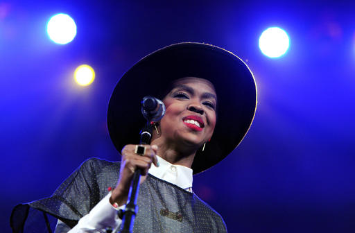 FILE - In this Feb. 5, 2014 file photo, singer Lauryn Hill performs at Amnesty International's "Bringing Human Rights Home" Concert at the Barclays Center in New York. Hill says that she will "make it up" to her fans after she enraged those in attendance at an Atlanta concert Friday, May 6, 2016, by arriving two hours late and performing for fewer than 40 minutes. (Photo by Evan Agostini/Invision/AP, File)