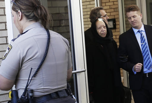 A deputy holds the door as Noreen Nelson, center, the half-sister of Prince, leaves the Carver County Courthouse Monday, May 2, 2016, in Chaska, Minn. where a judge has confirmed the appointment of a special administrator to oversee the settlement of Prince's estate. The pop rock singer died on April 21 at the age of 57. (AP Photo/Jim Mone)