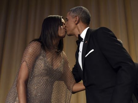 President Barack Obama, right, kisses first lady Michelle Obama, left, after he spoke at the annual White House Correspondents' Association dinner at the Washington Hilton in Washington, Saturday, April 30, 2016. (AP Photo/Susan Walsh)
