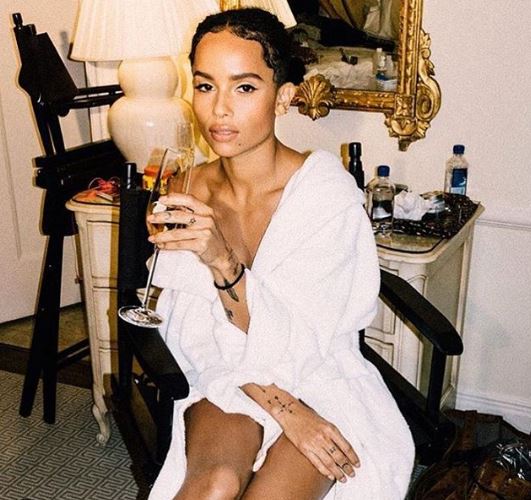 Zoe Kravitz had a glass of bubbly while getting her make up done.