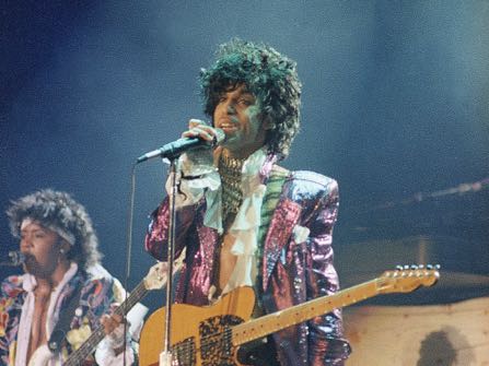 FILE - In this 1985 file photo, singer Prince performs in concert. The Revolution, The band that helped catapult Prince to international superstardom is reuniting in his memory. The Revolution, which backed up Prince in the 1980s, will play two shows Sept. 2-3, 2016, at First Avenue, the downtown Minneapolis nightclub where Prince and the Revolution filmed “Purple Rain.” (AP Photo/File)