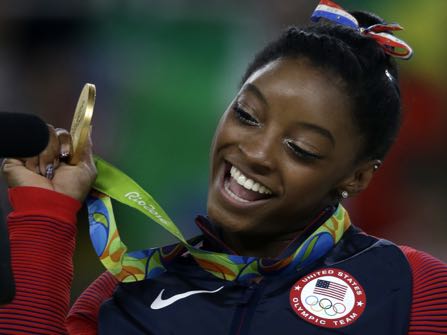 United States' Simone Biles displays her gold medal for floor during the artistic gymnastics women's apparatus final at the 2016 Summer Olympics in Rio de Janeiro, Brazil, Tuesday, Aug. 16, 2016. (AP Photo/Rebecca Blackwell)