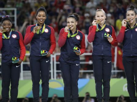 U.S. gymnasts, left to right, Simone Biles, Gabrielle Douglas, Lauren Hernandez, Madison Kocian and Aly Raisman hold their gold medals during the medal ceremony for the artistic gymnastics women's team at the 2016 Summer Olympics in Rio de Janeiro, Brazil, Tuesday, Aug. 9, 2016. (AP Photo/Julio Cortez)