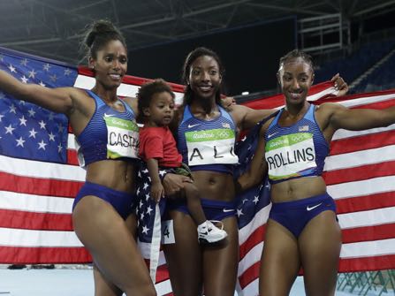 Gold medal winner Brianna Rollins, right, silver medal winner, Nia Ali, center, and bronze medal winner Kristi Castlin, left, all from the United States, celebrate with their country's flag, during the athletics competitions of the 2016 Summer Olympics at the Olympic stadium in Rio de Janeiro, Brazil, Wednesday, Aug. 17, 2016. (AP Photo/Matt Slocum)