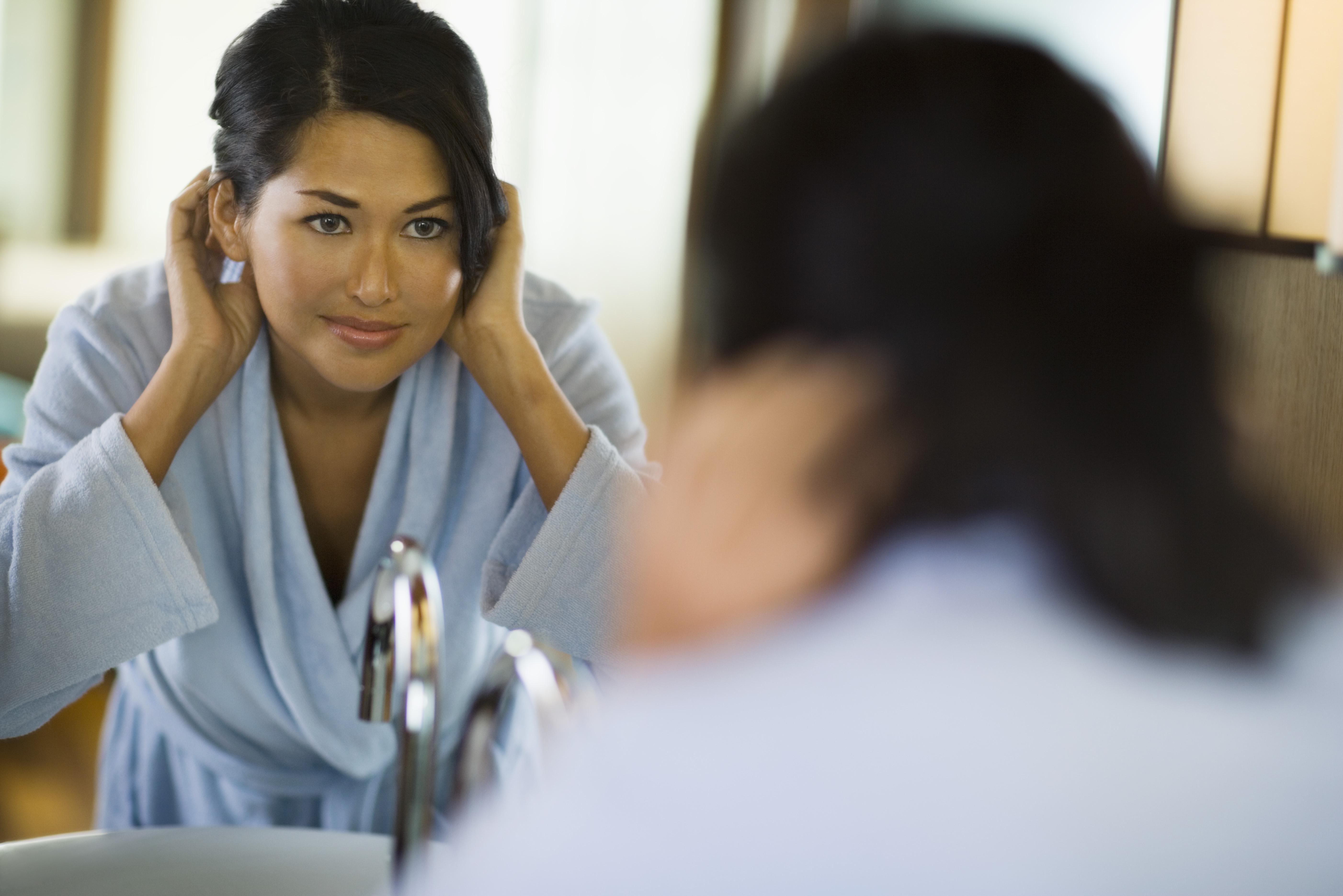 Woman looking in mirror