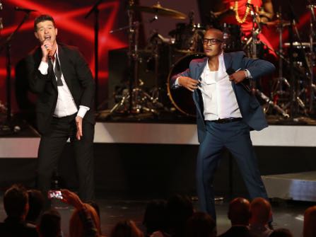 FILE- In this Dec. 6, 2013, file photo, Robin Thicke, left, and T.I. perform "Blurred Lines" at the Grammy Nominations Concert Live! at the Nokia Theatre L.A. Live in Los Angeles. More than 200 musicians filed a brief with the Ninth Circuit Court of Appeals on Tuesday, Aug. 30, 2016, to express concern about the ruling last year in a case brought by the children of Marvin Gaye, who sued for copyright infringement claiming "Blurred Lines" copied Gaye's hit "Got to Give it Up." (Photo by Matt Sayles/Invision/AP, File)