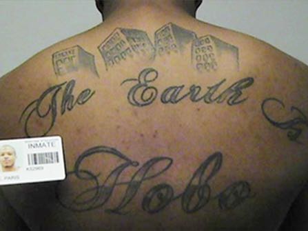 This undated photo in a court filing provided by the United States Attorney's office in Chicago, shows Paris Poe's back tattoo that reads 'The Earth Is Our Turf, and Hobo. Poe is one of six defendants on trial for racketeering and other charges are purported leaders of the widely feared Hobos, a South Side gang that federal prosecutors say murdered, maimed and tortured their way into control of some of Chicago's most lucrative drug markets. Their federal trial begins Wednesday, Sept. 14, 2016 with opening statements in Chicago. (United States Attorney's office in Chicago via AP)