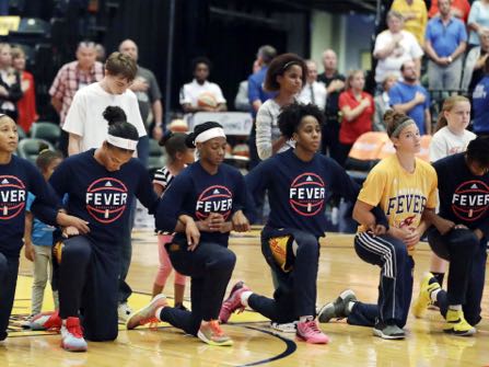 Members of the Indiana Fever kneel during the playing of the national anthem before the start of of a first round WNBA playoff basketball game, against the Phoenix Mercury, Wednesday, Sept. 21, 2016, in Indianapolis. (AP Photo/Darron Cummings)