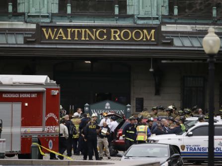 Emergency officials stand outside of the Hoboken Terminal following a train crash, Thursday, Sept. 29, 2016, in Hoboken, N.J. A commuter train has crashed into the rail station during the morning rush hour, causing serious damage. (AP Photo/Julio Cortez)