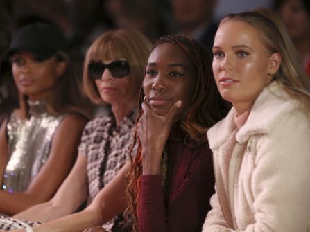 Caroline Wozniacki, from right, Venus Williams and Anna Wintour watch as the Serena Williams Signature Statement Spring 2017 collection is modeled during Fashion Week in New York, Monday, Sept. 12, 2016. (AP Photo/Seth Wenig)