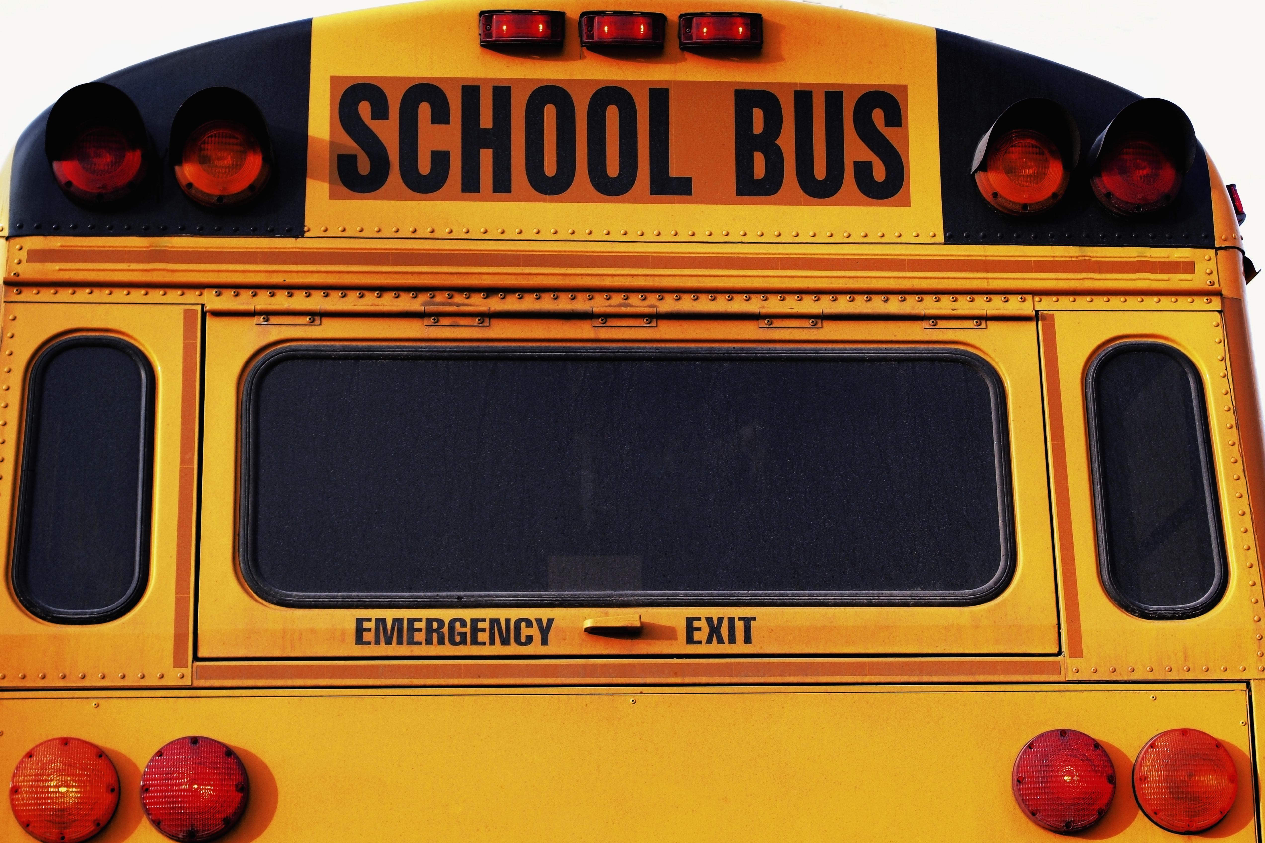 Front of yellow school bus, close-up, part of