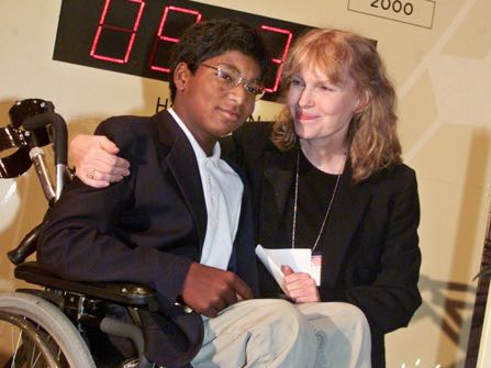 HOLD FOR STORY CONFIRMATION - FILE - In this Sept. 27, 2000 file photo, actress Mia Farrow puts her arm around her adopted son Thaddeus as they participate in the global summit on polio eradication at United Nations headquarters. Farrow, who suffered from the disease as a child, and her 12-year-old son who is paralyzed by it, joined U.N. Secretary General Kofi Annan in starting a clock to countdown the number of polio cases until 2005. (AP Photo/Richard Drew, File)