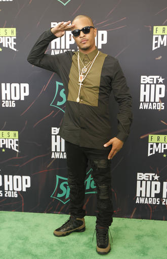 Hip Hop artist T.I. poses for photographers as he arrives for the BET Hip Hop Awards in Atlanta, Saturday, Sept. 17, 2016. (AP Photo/Tami Chappell)