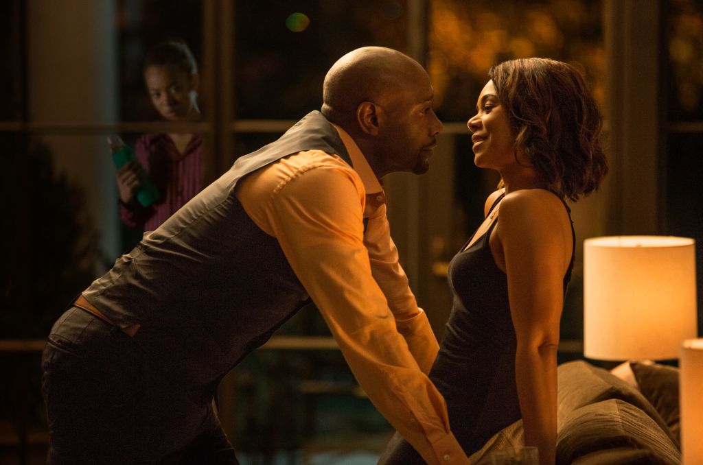 John Taylor (MORRIS CHESTNUT) with his wife Laura (REGINA HALL) have a romantic moment while Anna (Jaz Sinclair) watches them from outside in Screen Gems' WHEN THE BOUGH BREAKS.