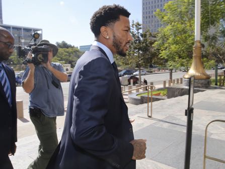 New York Knicks guard Derrick Rose, right, arrives at Los Angeles U.S. District Court downtown Los Angeles on Thursday, Oct. 6, 2016. A six-woman, two-man jury has been seated in the trial of a civil lawsuit brought against New York Knicks guard Derrick Rose by an ex-girlfriend who alleges the NBA star and two of his friends drugged and sexually assaulted her. (AP Photo/Damian Dovarganes)