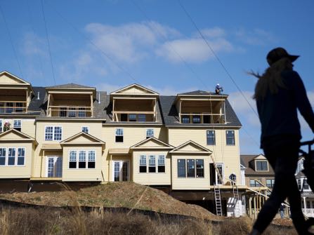 FILE - In this Wednesday, Feb. 17, 2016, file photo, town homes stand under construction as a pedestrian walks along the BeltLine in Atlanta. First-time buyers may be entering the U.S. home market in greater numbers than industry watchers had assumed. Nearly half of sales in the past year went to people who were buying their first home, according to a survey released Tuesday, Oct. 18, 2016, by the real estate firm Zillow. That’s a much higher proportion of the market than other industry estimates had indicated. (AP Photo/David Goldman, File)
