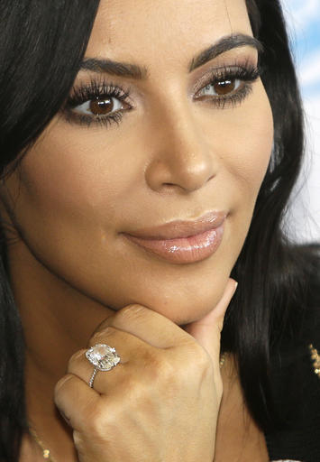 FILE - In this June 24, 2015 file photo, American TV personality Kim Kardashian attends the Cannes Lions 2015, International Advertising Festival in Cannes, southern France. Armed robbers forced their way into a private Paris residence where Kardashian West was staying, and stole more than $10 million worth of jewelry, police officials said Monday, Oct. 3, 2016. They said five assailants, who are still at large, stole a jewelry box containing valuables worth 6 million euros ($6.7 million) as well as a ring worth 4 million euros ($4.5 million). (AP Photo/Lionel Cironneau, File)