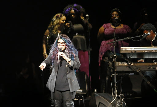 Tyka Nelson, Prince's sister, appears on stage during a tribute concert honoring the late musician at Xcel Arena, Thursday, Oct. 13, 2016, in St. Paul, Minn. Prince died in April of an accidental overdose. (AP Photo/Jim Mone)