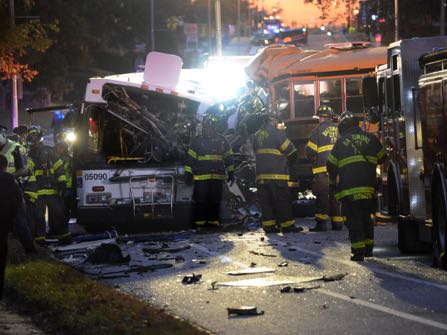 Fire department and rescue officials are at the scene of an early morning fatal collision between a school bus and a commuter bus Tuesday, Nov. 1, 2016, in Baltimore. (Jeffrey F. Bill/Baltimore Sun via AP)