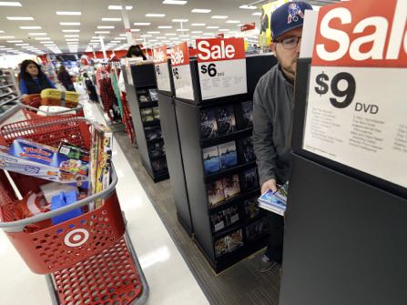 Paul Poirier shops for sales at Target on Black Friday, Nov. 25, 2016, in Wilmington, Mass. Stores open their doors Friday for what is still one of the busiest days of the year, even as the start of the holiday season edges ever earlier. (AP Photo/Elise Amendola)
