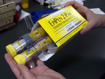 In this Friday, July 8, 2016, photo, pharmacist Clint Hopkins, owner of Pucci's Pharmacy, displays a package of EpiPens, an epinephrine autoinjector for the treatment of allergic reactions, in Sacramento, Calif. Frustrated by the rising cost of prescription drugs, health advocates hope sunlight and a dose of shame might discourage drugmakers from raising their prices too quickly or introducing new medications at prices that break the bank. (AP Photo/Rich Pedroncelli)