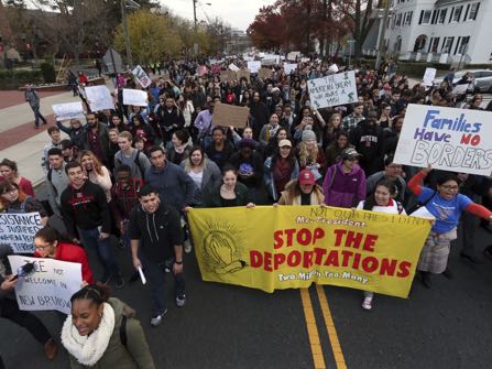 Hundreds of Rutgers University students block College Ave., in New Brunswick, N.J., as they march to protest some of President elect Donald Trump's policies and to ask school officials to denounce some of his plans at Rutgers University Wednesday, Nov. 16, 2016, in New Brunswick, N.J. College students at campuses around the United States say they are planning rallies and walkouts to call on school administrators to protect students and employees against immigration proceedings under Donald Trump's presidency. (AP Photo/Mel Evans)