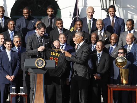 President Barack Obama accepts a team basketball jersey from Cleveland Cavaliers team members Kevin Love, left, as the president honored the 2016 NBA Champions the Cleveland Cavaliers basketball team during a ceremony on the South Lawn of the White House in Washington, Thursday, Nov. 10, 2016. (AP Photo/Pablo Martinez Monsivais)