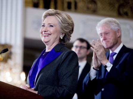 FILE- In this Nov. 9, 2016, file photo, Hillary Clinton, accompanied by former President Bill Clinton, right, pauses while speaking to staff and supporters at the New Yorker Hotel in New York. Hillary Clinton introduced singer and UNICEF Goodwill Ambassador Katy Perry on Tuesday, Nov. 29, at the annual event in New York. (AP Photo/Andrew Harnik, File)