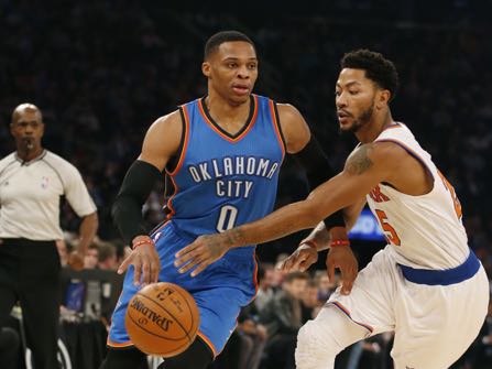 New York Knicks guard Derrick Rose (25) challenges Oklahoma City Thunder guard Russell Westbrook (0) as Westbrook drives to the basket in the first half of an NBA basketball game at Madison Square Garden in New York, Monday, Nov. 28, 2016. The Thunder defeated the Knicks 112-103. (AP Photo/Kathy Willens)