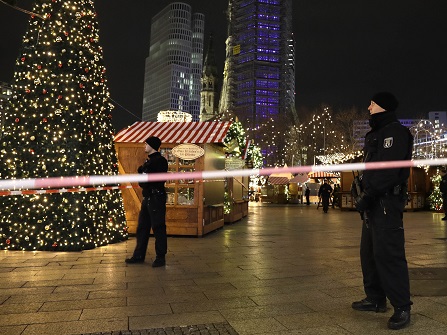 Police guard a Christmas market after a truck ran into the crowded Christmas market in Berliin Berlin, Germany, Monday, Dec. 19, 2016. (AP Photo/Michael Sohn)