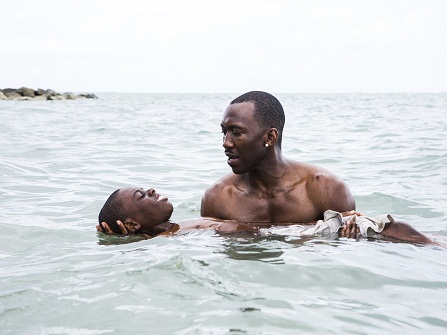 This image released by A24 shows Alex Hibbert, foreground, and Mahershala Ali in a scene from the film, "Moonlight." The film was nominated for a Golden Globe award for best motion picture drama on Monday, Dec. 12, 2016. The 74th Golden Globe Awards ceremony will be broadcast on Jan. 8, on NBC. (David Bornfriend/A24 via AP)