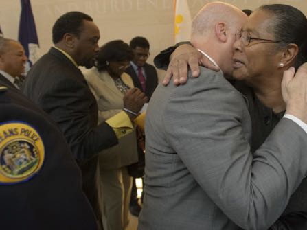 New Orleans Mayor Mitch Landrieu hugs jackie Madison Brown, whose brother Ronald Madison was killed by New Orleans Police on Danziger Bridge after Hurricane Katrina in 2005, after the mayor held a press conference to announce the settlements in the civil rights cases stemming from several New Orleans Police Department-involved incidents surrounding Hurricane Katrina at Xavier University's St. Katharine Drexel Chapel in New Orleans, La. Monday, Dec. 19, 2016. The city said it will pay out $13.3 million to 17 plaintiffs.