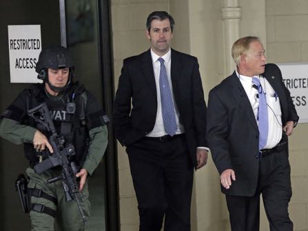 Former North Charleston police officer Michael Slager, center, is escorted from the courthouse during his murder trial at the Charleston County court in Charleston, S.C., Friday, Dec. 2, 2016. The case of a former South Carolina police officer charged with murder in the shooting death of an unarmed black motorist is now before the jury. (AP Photo/Chuck Burton)