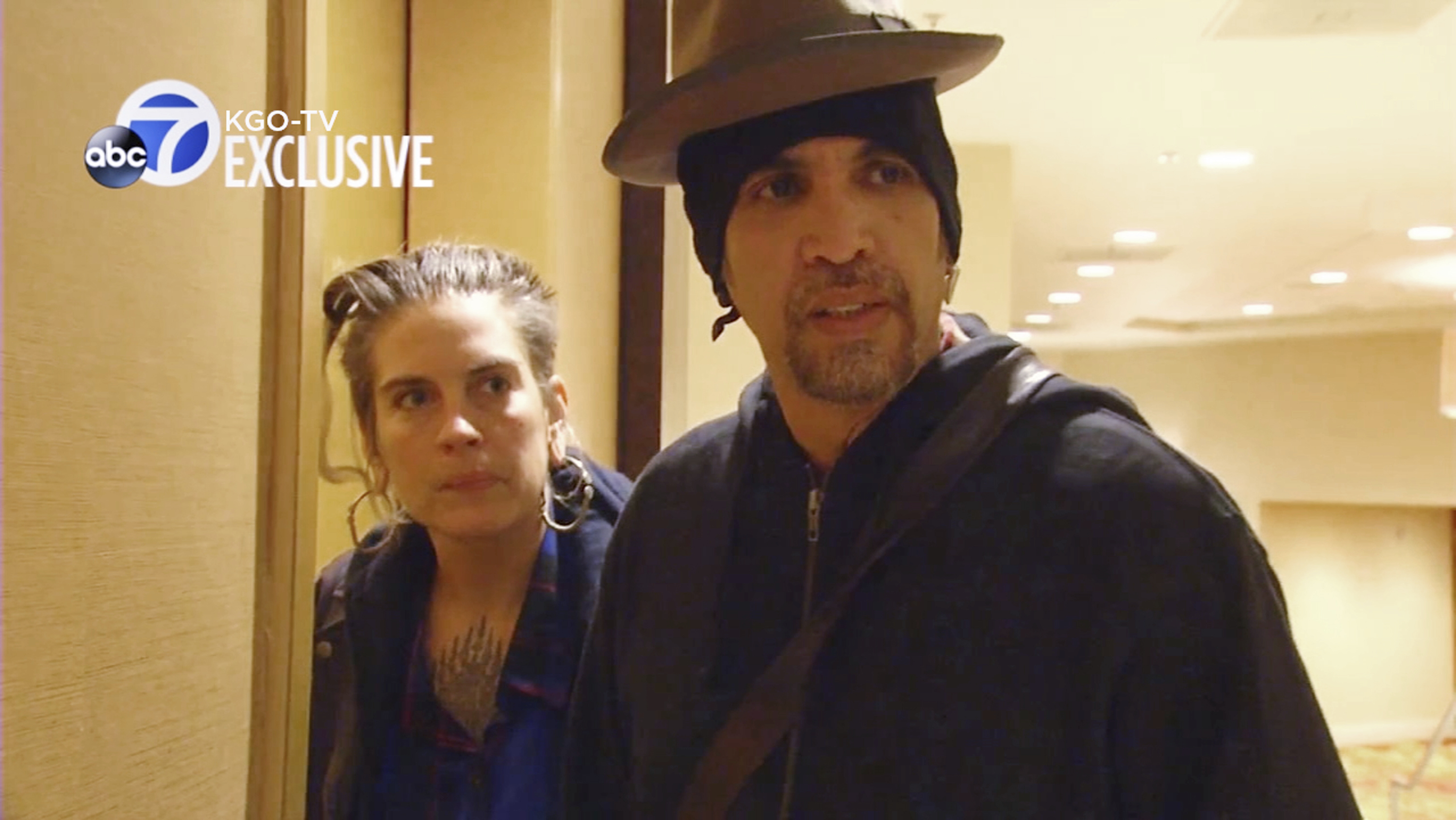 This still frame from exclusive video provided by San Francisco TV station KGO-TV, made late Sunday, Dec. 4, 2016, shows Derick Ion Almena, right, and Micah Allison, the couple who operated the Ghost Ship warehouse where dozens have died in a fire, at the Oakland, Calif., Marriott Hotel. When a KGO reporter asked if he had anything to say to the families of those who were killed, Almena said: "They're my children. They're my friends, they're my family, they're my loves, they're my future. What else do I have to say?" (KGO-TV via AP)