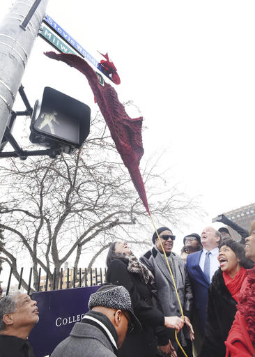 Motown legend Stevie Wonder unveils the new street sign "Stevie Wonder Ave." along with Motown Museum chairwoman Robin Terry, Detroit Mayor Mike Duggan, City Council President Brenda Jones and Congresswoman Brenda Lawrence. during a ceremony in Detroit, Wednesday, Dec. 21, 2016.  A portion of Milwaukee Street was renamed Stevie Wonder Ave. (Daniel Mears/Detroit News via AP)