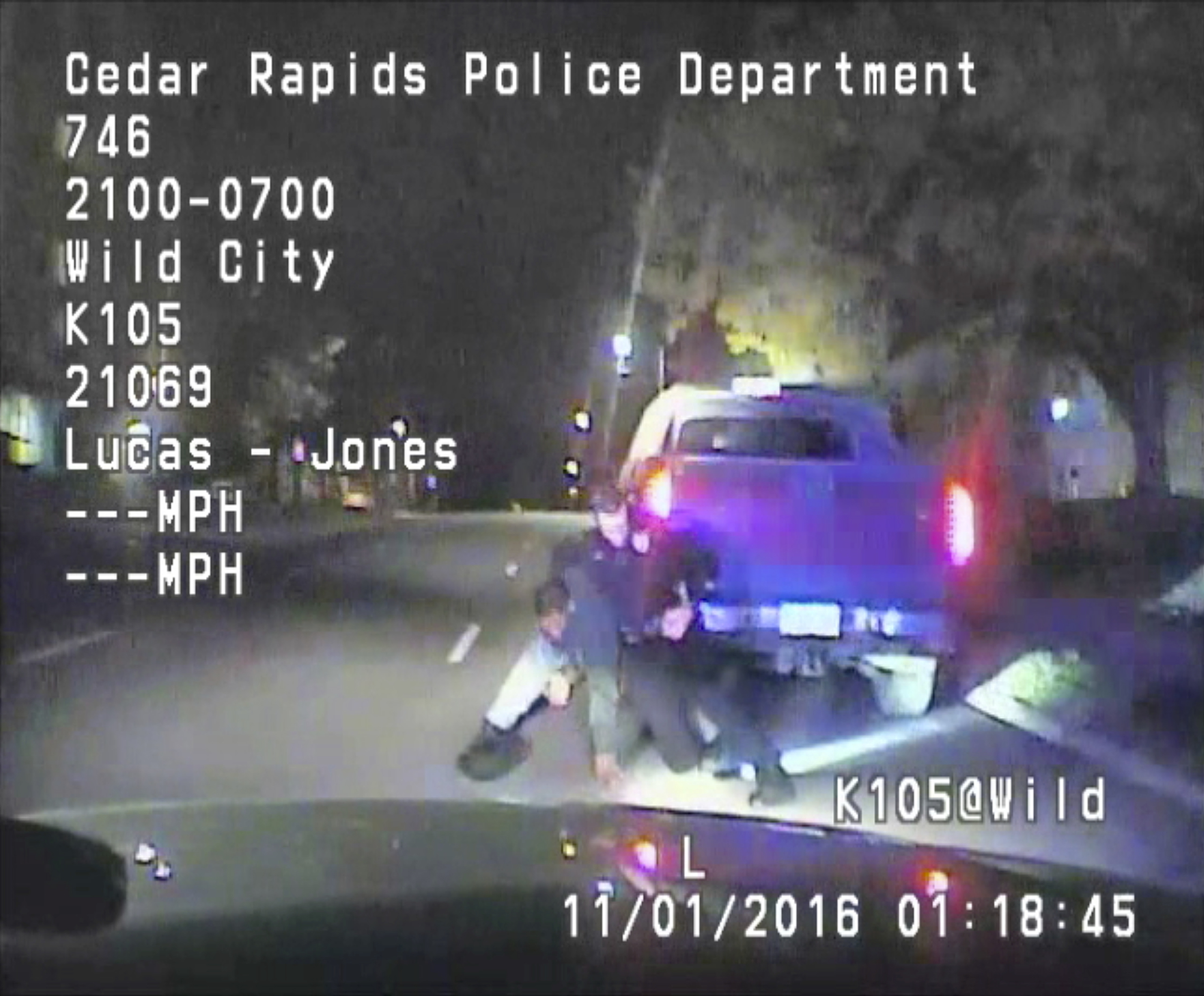 In this image made from a Nov. 1, 2016 dashcam video released Thursday, Dec. 8, 2016, by Cedar Rapids Police Department, an unarmed black motorist struggles with an Iowa officer and a police dog before the driver is shot and paralyzed. The video shows that 37-year-old Jerime Mitchell rushes back to his pickup truck and Cedar Rapids officer Lucas Jones shoots him as the vehicle rolls away. (Cedar Rapids Police Department via AP)