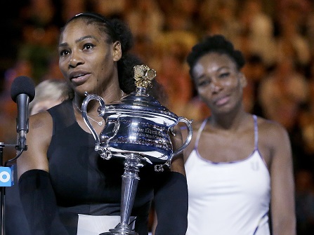 United States' Serena Williams, left, holds her trophy after defeating her sister, Venus, right, in the women's singles final at the Australian Open tennis championships in Melbourne, Australia, Saturday, Jan. 28, 2017. (AP Photo/Aaron Favila)