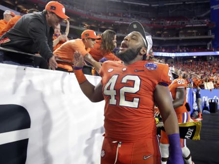 Clemson defensive lineman Christian Wilkins (42) greets fans after the Fiesta Bowl NCAA college football game against Ohio State, Saturday, Dec. 31, 2016, in Glendale, Ariz. Clemson won 31-0 to advance to the BCS championship game on Jan. 9th against Alabama. (AP Photo/Rick Scuteri)