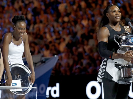 United States' Serena Williams holding her trophy at right, addresses the spectators, in front of her sister Venus, second from left, and former champion Hana Mandlikova, after her women's singles final victory, at the Australian Open tennis championships in Melbourne, Australia, Saturday, Jan. 28, 2017. (AP Photo/Kin Cheung)