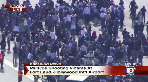 In this still image from video provided by NBC TV Local10, people stand on the tarmac after shots were fired at the international airport in Fort Lauderdale, Fla., Friday, Jan. 6, 2017. Local10 and other news media outlets reported Friday that multiple people were shot. (NBC TV Local10 via AP)