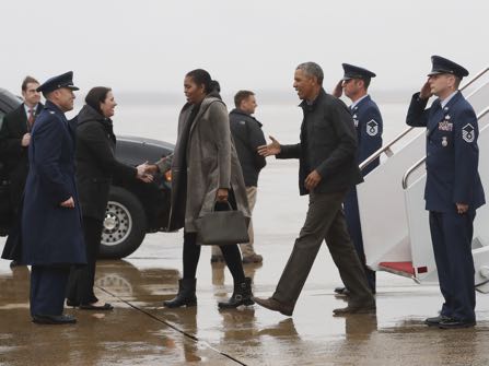 President Barack Obama, first lady Michelle Obama are greeted as they arrive on Air Force One, Monday, Jan. 2, 2017, in Andrews Air Force Base, Md., en route to Washington as they return from their annual vacation in Hawaii. (AP Photo/Carolyn Kaster)