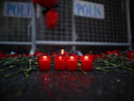 Candles are lit for the victims outside a nightclub which was attacked by a gunman overnight, in Istanbul, on New Year's Day, Sunday, Jan 1, 2017. An assailant armed with a long-barrelled weapon, opened fire at a nightclub in Istanbul's Ortakoy district during New Year's celebrations, killing dozens of people and wounding dozens of others in what the province's governor described as a terror attack. (AP Photo/Emrah Gurel)