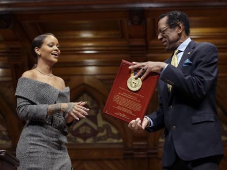 Singer Rihanna, left, is presented with the 2017 Harvard University Humanitarian of the Year Award by Allen Counter, director of the Harvard Foundation, right, during ceremonies at the school, Tuesday, Feb. 28, 2017, in Cambridge, Mass. (AP Photo/Steven Senne)
