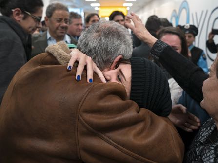 Family members who have just arrived from Syria embrace and are greeted by family who live in the United States upon their arrival at John F. Kennedy International Airport in New York, Monday, Feb. 6, 2017. (AP Photo/Craig Ruttle)