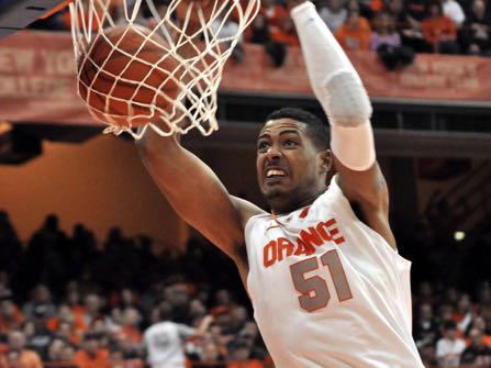 FILE - In this Jan. 14, 2012, file photo, Syracuse's Fab Melo dunks against Providence during an NCAA college basketball game in Syracuse, N.Y. Military police said that former Syracuse and Celtics center Melo died in his native Brazil. A police sergeant said an emergency call Saturday, Feb. 11, 2017 brought police and paramedics to Melo’s house, but that when the police arrived, paramedics said Melo was dead. (AP Photo/Kevin Rivoli, File)
